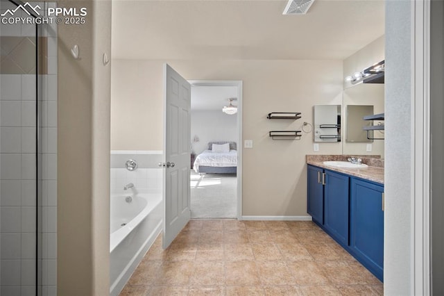 bathroom featuring baseboards, visible vents, ensuite bath, vanity, and a bath