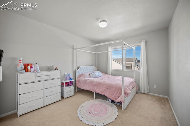 bedroom featuring light carpet and baseboards