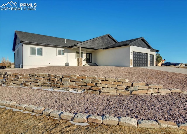 single story home featuring driveway, an attached garage, and stucco siding