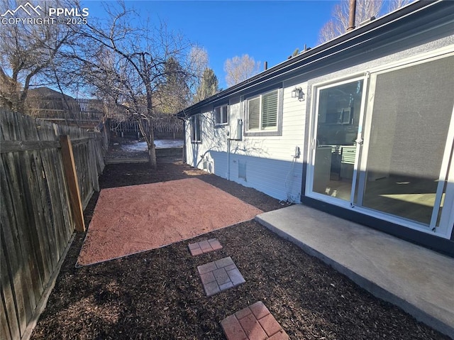 view of yard featuring a patio area and a fenced backyard