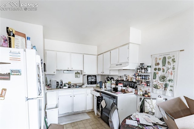 kitchen with white cabinetry, sink, white fridge, and electric stove