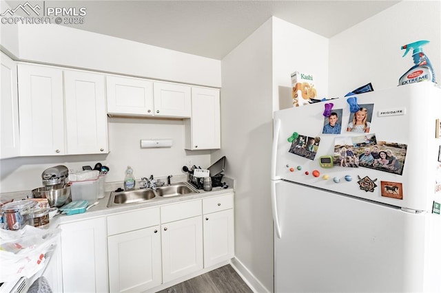 kitchen featuring sink, white cabinetry, dark wood-type flooring, and white fridge