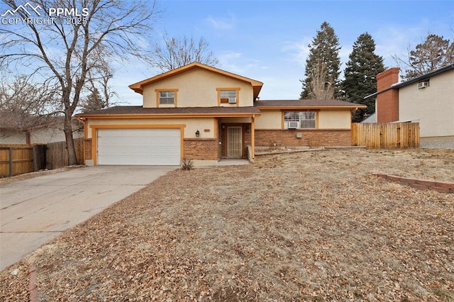 view of front of home with brick siding, concrete driveway, fence, cooling unit, and stucco siding