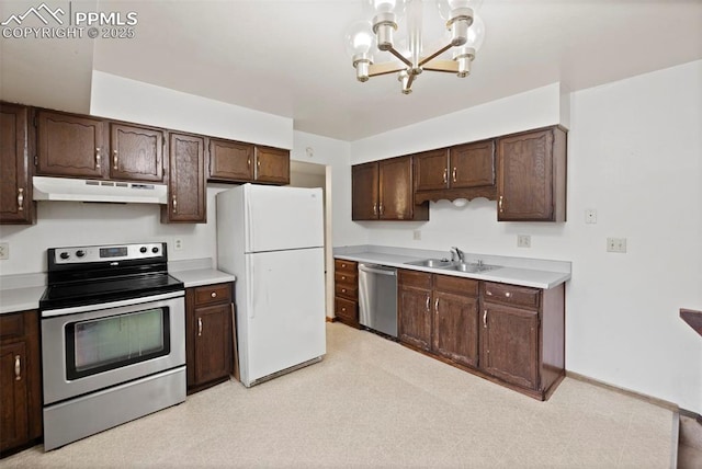 kitchen with light floors, stainless steel appliances, dark brown cabinets, under cabinet range hood, and a sink