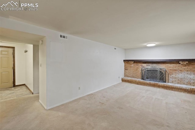 unfurnished living room with baseboards, a brick fireplace, visible vents, and light colored carpet