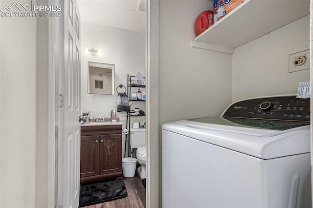 clothes washing area featuring washer / dryer and dark wood finished floors