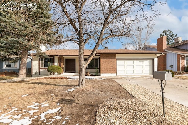 ranch-style house featuring concrete driveway, brick siding, and an attached garage