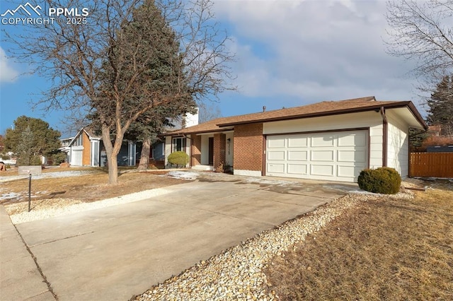 ranch-style home featuring an attached garage, concrete driveway, and brick siding