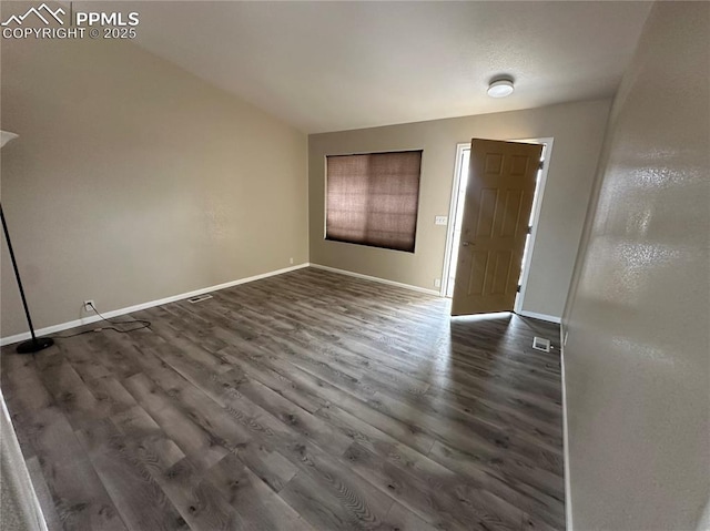 entrance foyer featuring dark wood finished floors, visible vents, and baseboards