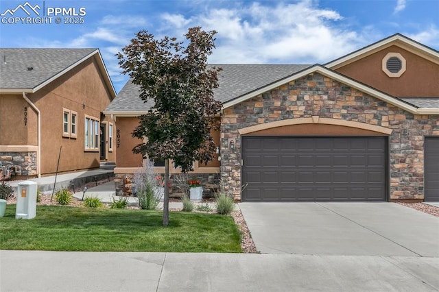 view of front of home featuring driveway, roof with shingles, an attached garage, and stucco siding