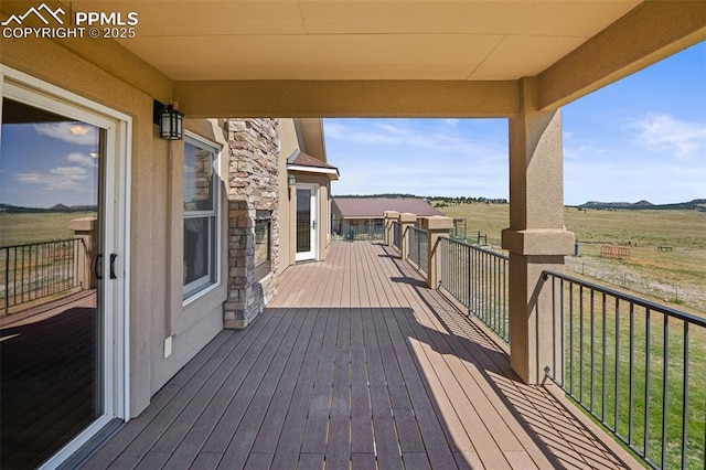 wooden deck featuring a rural view