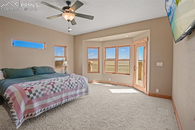 carpeted bedroom featuring baseboards, a ceiling fan, and access to exterior