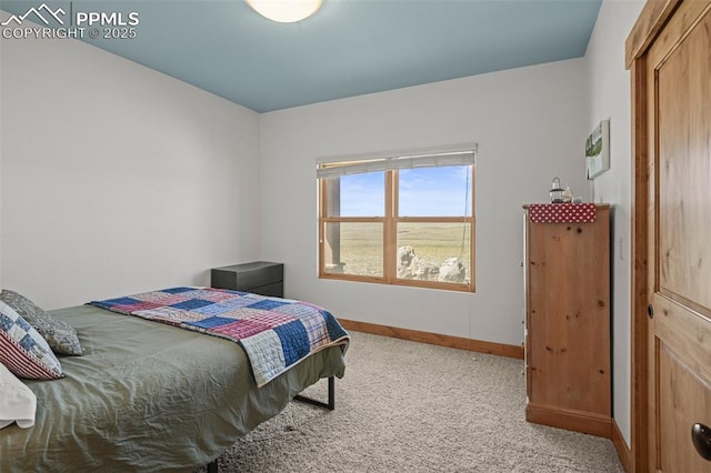 carpeted bedroom featuring baseboards