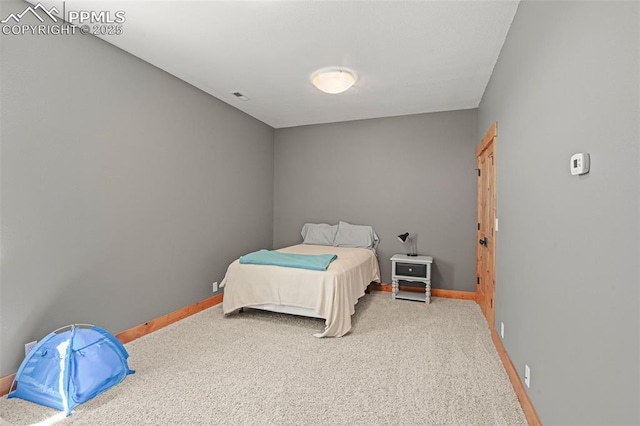 bedroom featuring carpet floors, visible vents, and baseboards