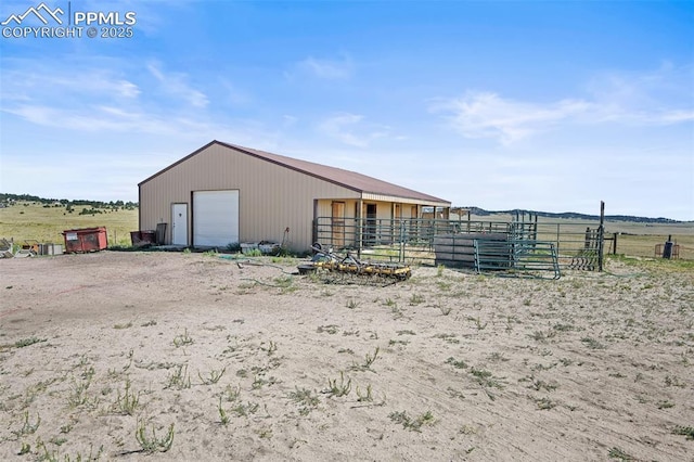 view of pole building featuring driveway and a rural view