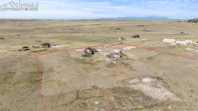 aerial view featuring a mountain view and a rural view