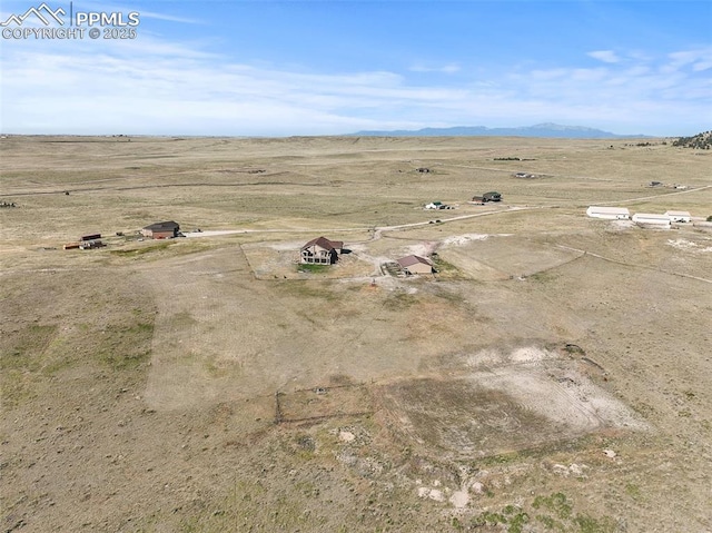 drone / aerial view featuring a mountain view and a rural view