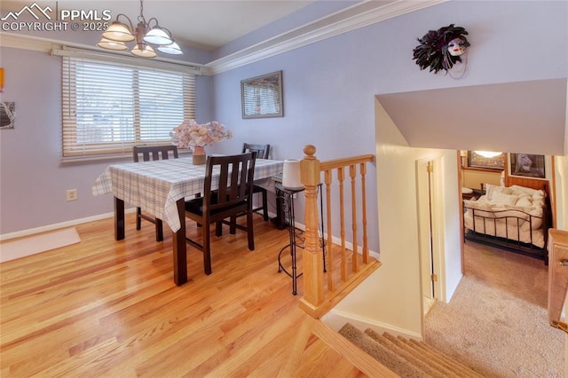 dining room with baseboards, light wood-style flooring, ornamental molding, and a notable chandelier