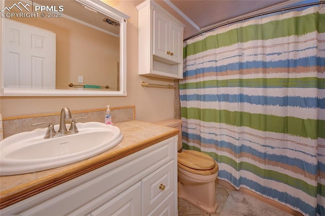 bathroom featuring curtained shower, vanity, and toilet