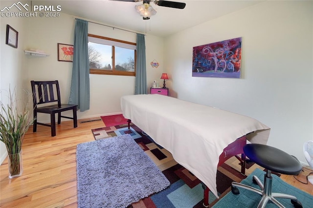 bedroom featuring wood finished floors and baseboards