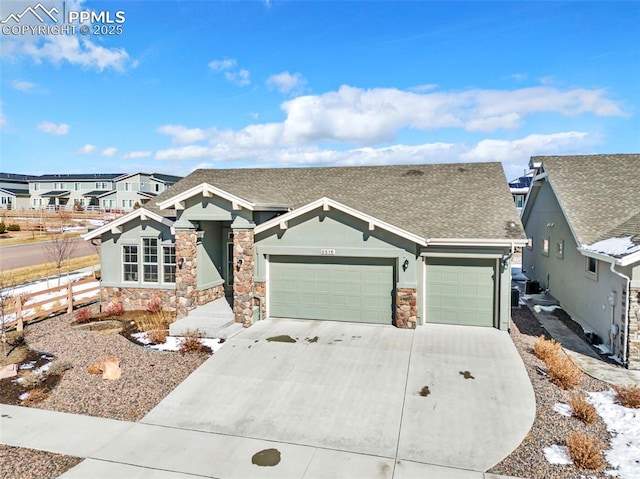 view of front of property featuring a garage, driveway, a shingled roof, stone siding, and stucco siding