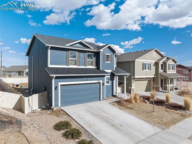 traditional-style home featuring a residential view, fence, driveway, and an attached garage