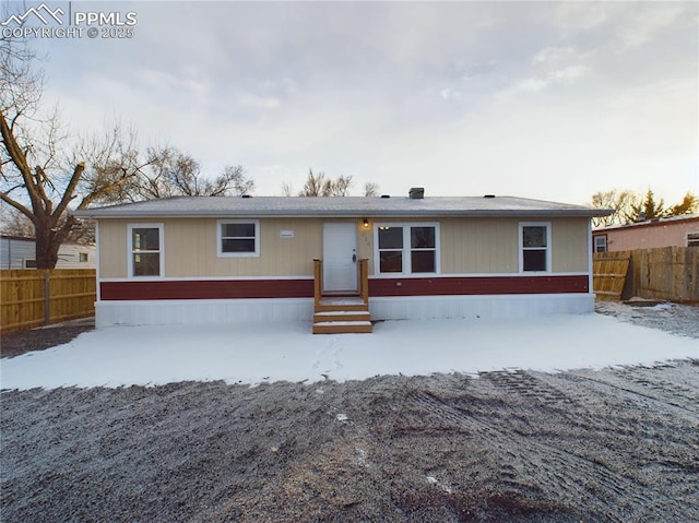 manufactured / mobile home featuring entry steps and a fenced backyard