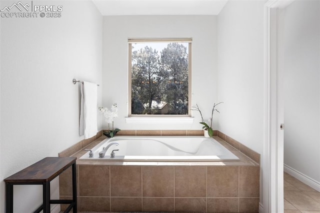 bathroom with a garden tub and tile patterned floors