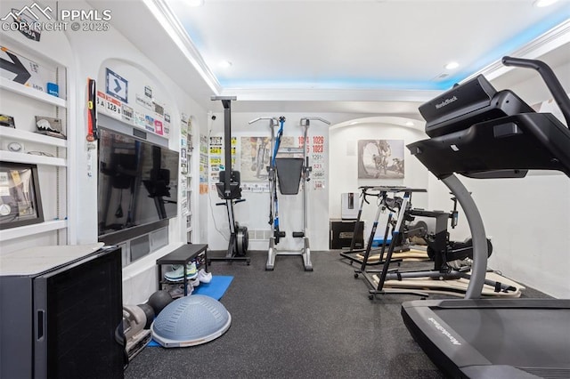 workout area featuring crown molding and recessed lighting