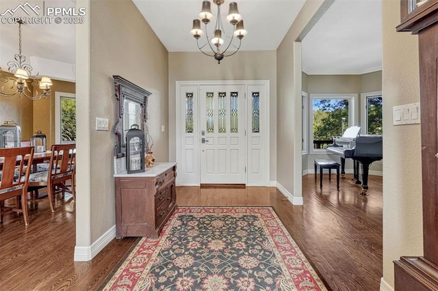 entryway featuring dark wood-style floors, baseboards, and a notable chandelier