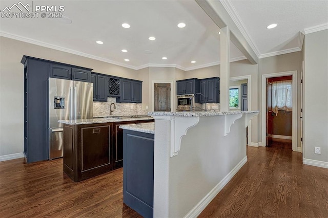 kitchen with an island with sink, a kitchen bar, stainless steel appliances, and dark wood-type flooring