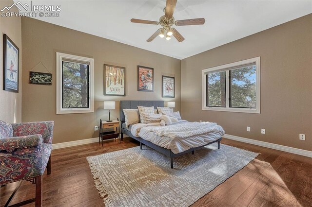 bedroom featuring ceiling fan, baseboards, and wood finished floors