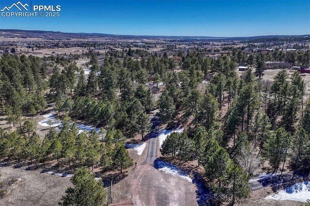 aerial view featuring a wooded view