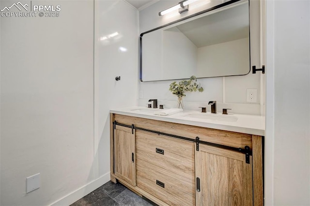 bathroom with a sink, baseboards, and double vanity