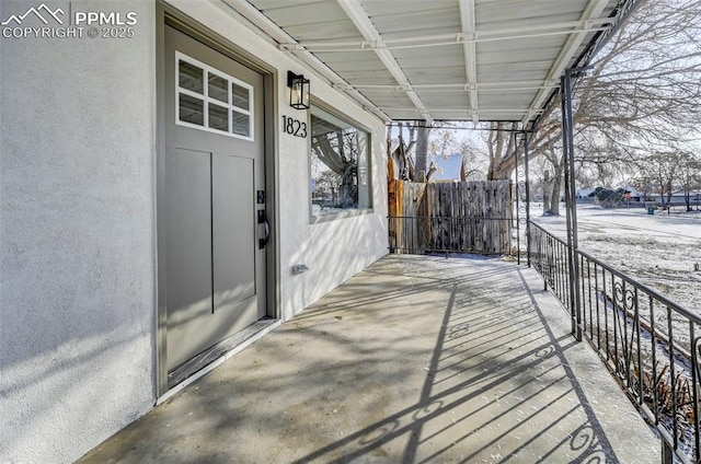 snow covered deck featuring fence