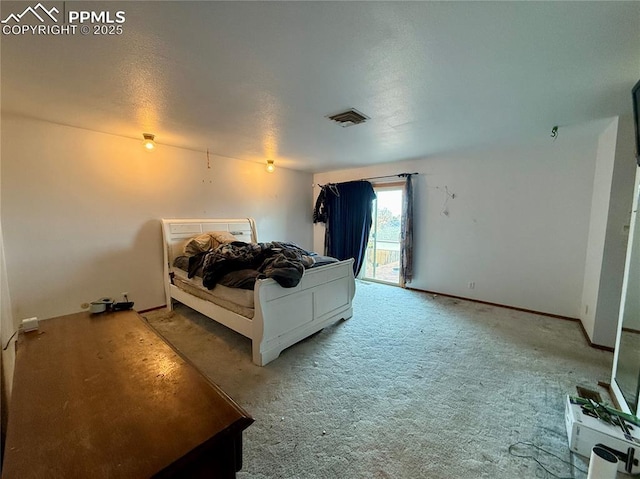 carpeted bedroom featuring access to exterior, visible vents, and baseboards