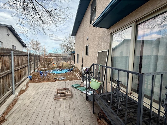 wooden terrace featuring a fenced backyard and a grill