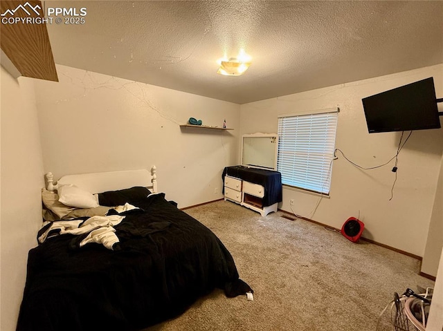 bedroom featuring a textured ceiling, carpet flooring, and baseboards