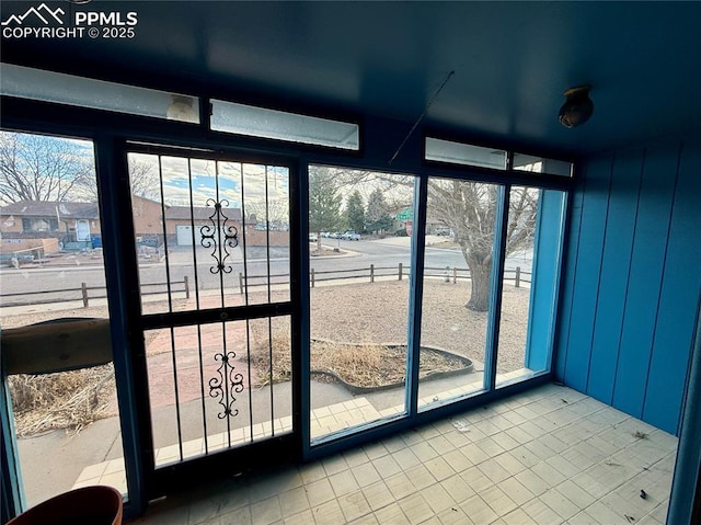 doorway to outside featuring expansive windows