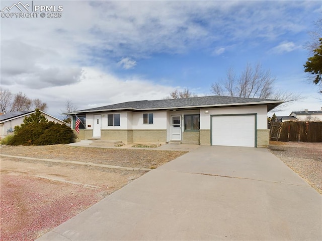 ranch-style house with driveway, brick siding, an attached garage, and fence