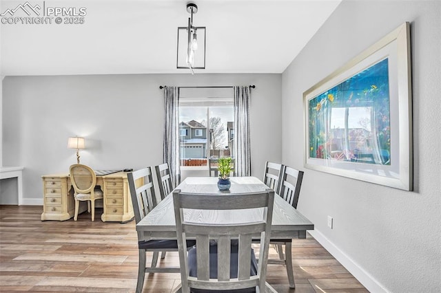 dining area featuring baseboards and wood finished floors