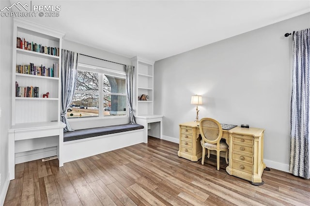 office space featuring baseboards and wood finished floors