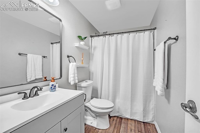 full bathroom with toilet, wood finished floors, vanity, and a shower with curtain