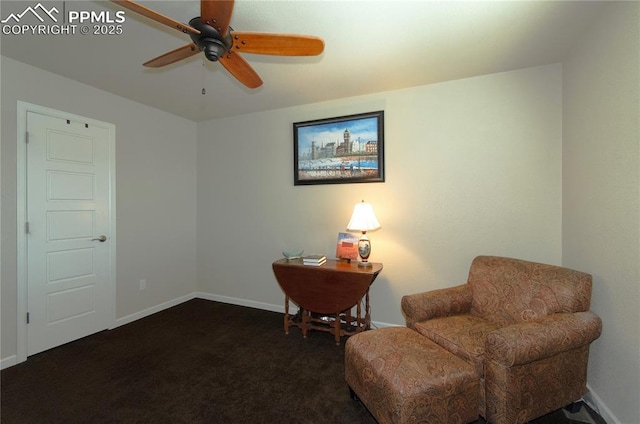 living area with dark carpet, a ceiling fan, and baseboards