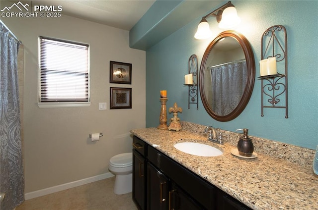 bathroom with baseboards, vanity, toilet, and tile patterned floors