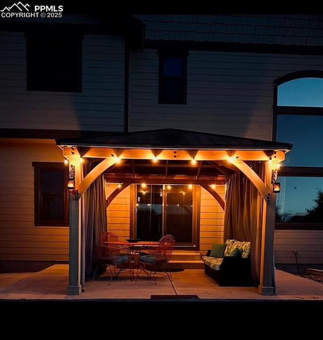 back of house with entry steps and a gazebo