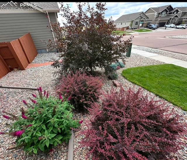 view of yard featuring a residential view and fence