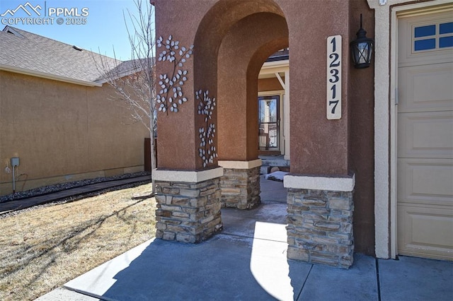 entrance to property with stucco siding