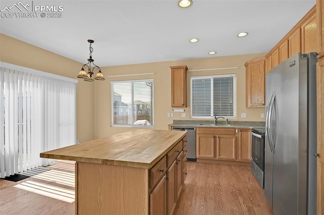 kitchen featuring stainless steel appliances, recessed lighting, wooden counters, light wood-style flooring, and a sink