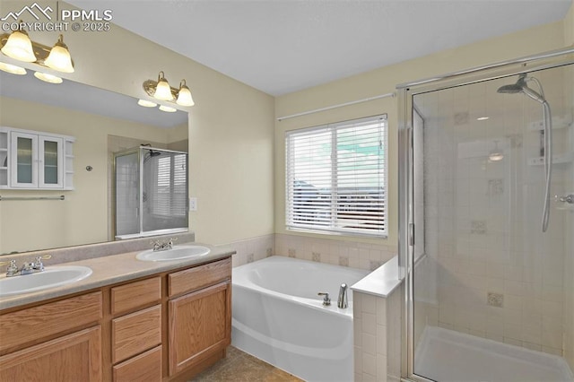 full bathroom with a garden tub, double vanity, a stall shower, and a sink